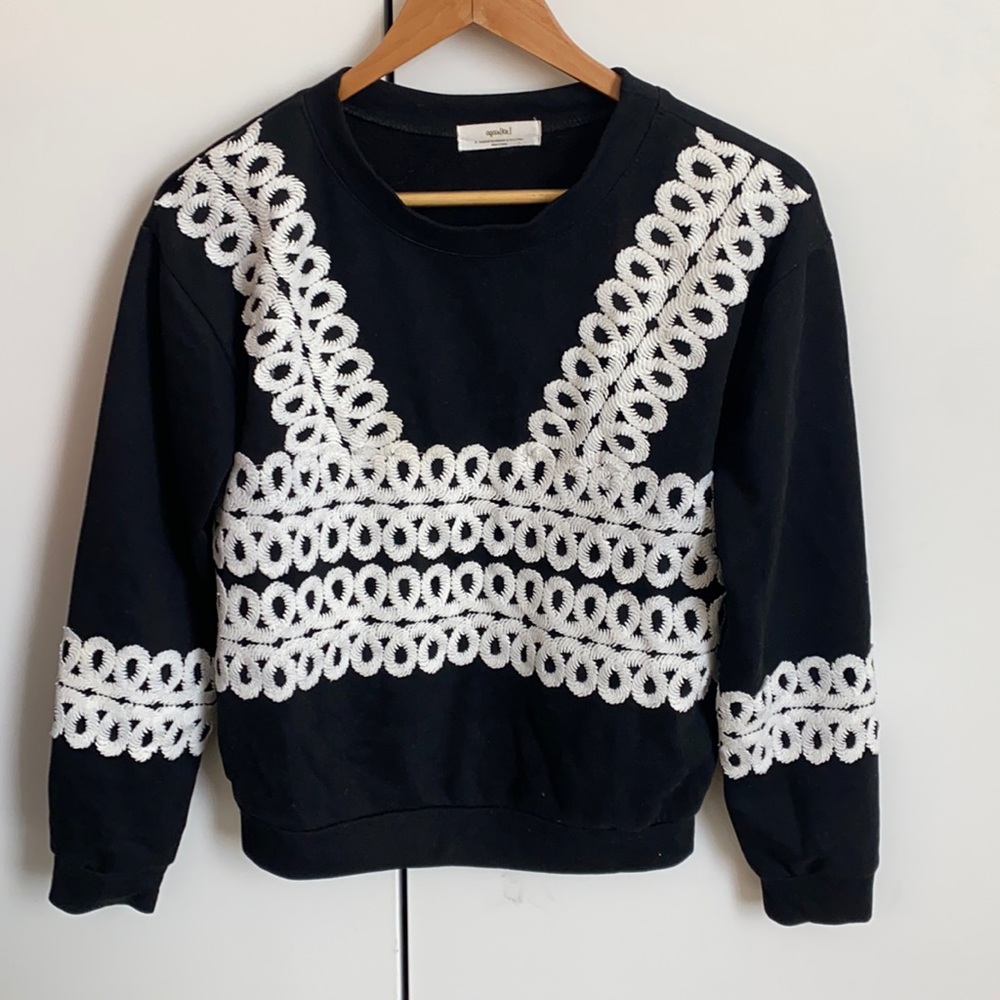 Black women’s sweater with white embroider detail